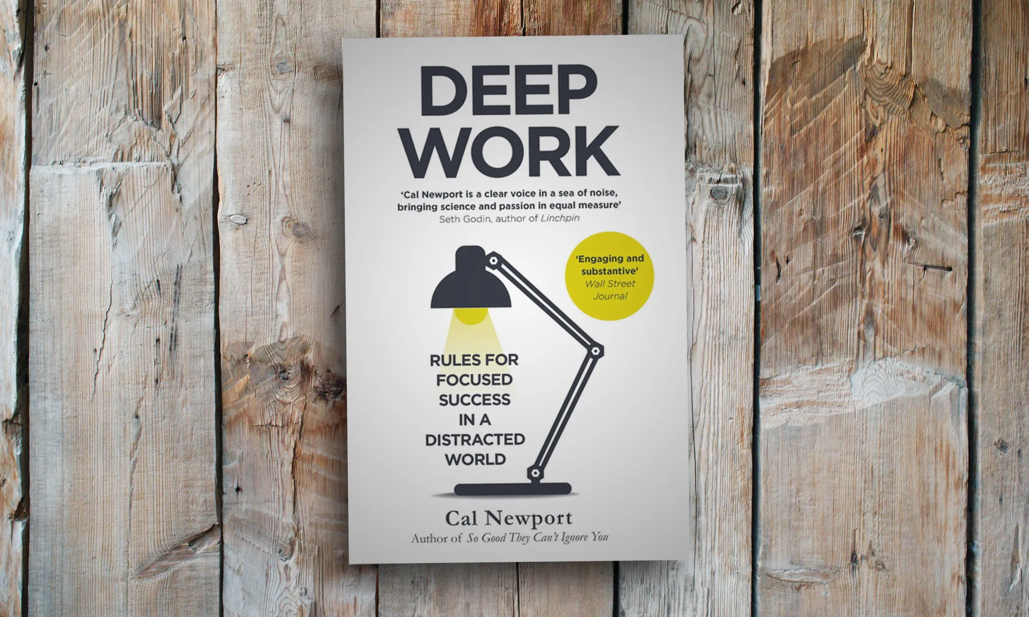 A copy of Cal Newport's Deep Work on a wooden surface.